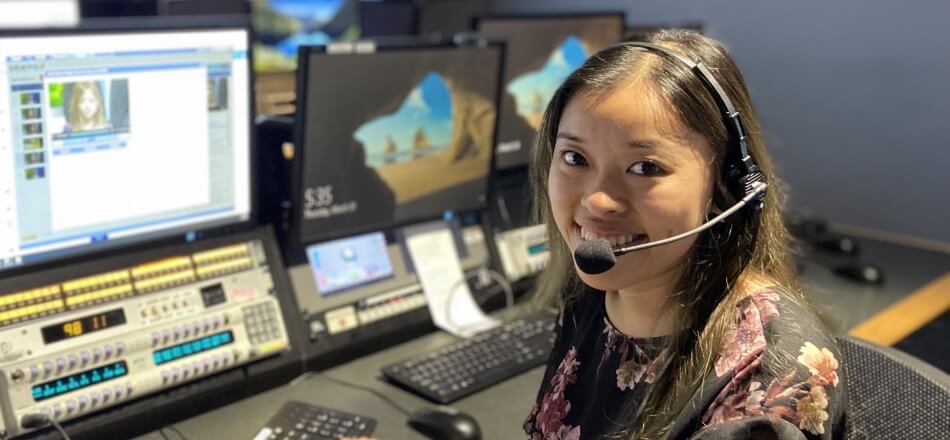 A woman sat at a producer's desk